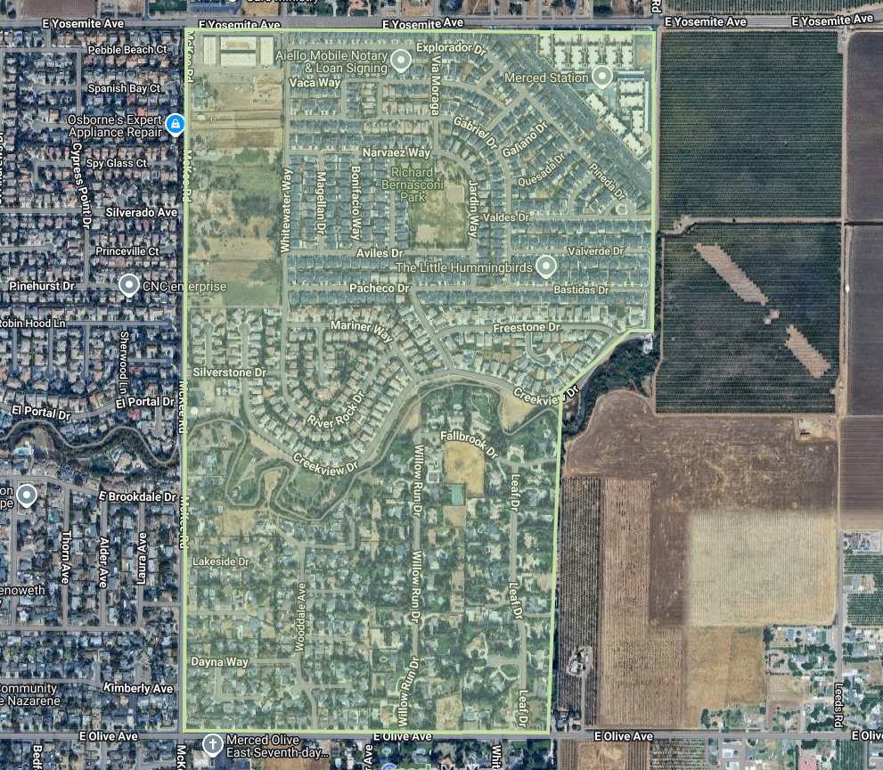 The image shows a map of a suburban area with streets, parks, and nearby agricultural land.