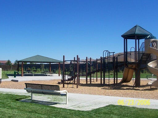May contain: bench, furniture, plant, grass, park, outdoors, lawn, play area, and playground