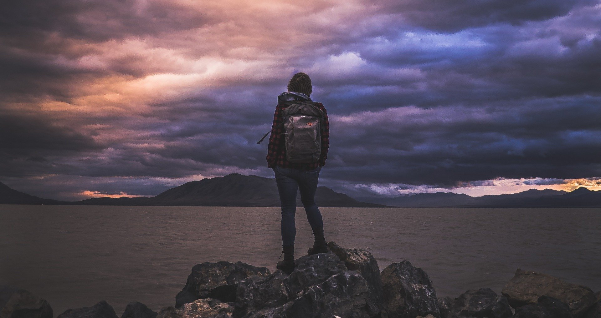 May contain: bag, person, standing, photography, nature, outdoors, sky, backpack, and backpacking