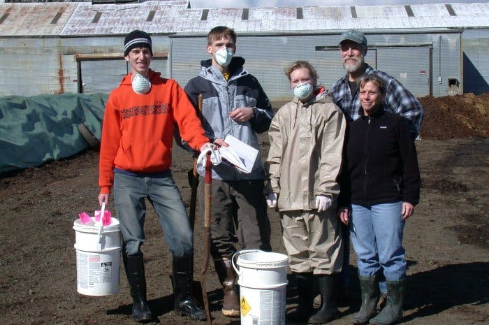 May contain: soil, people, person, clothing, pants, hardhat, helmet, adult, male, man, glove, coat, jacket, face, head, photography, and portrait