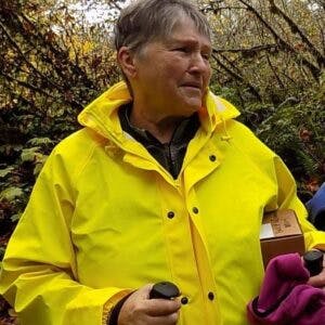 May contain: clothing, coat, raincoat, and person