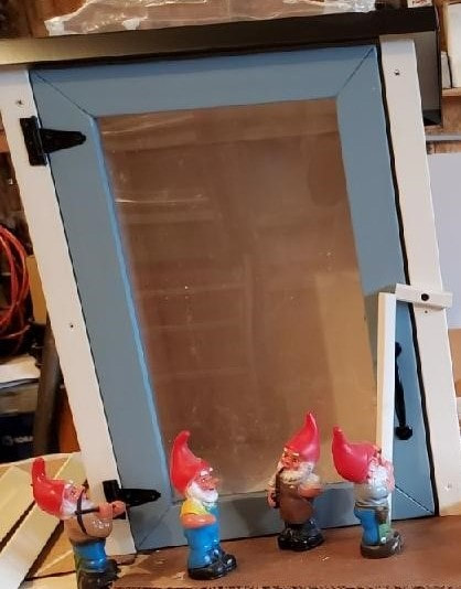 Toy gnomes working on a door