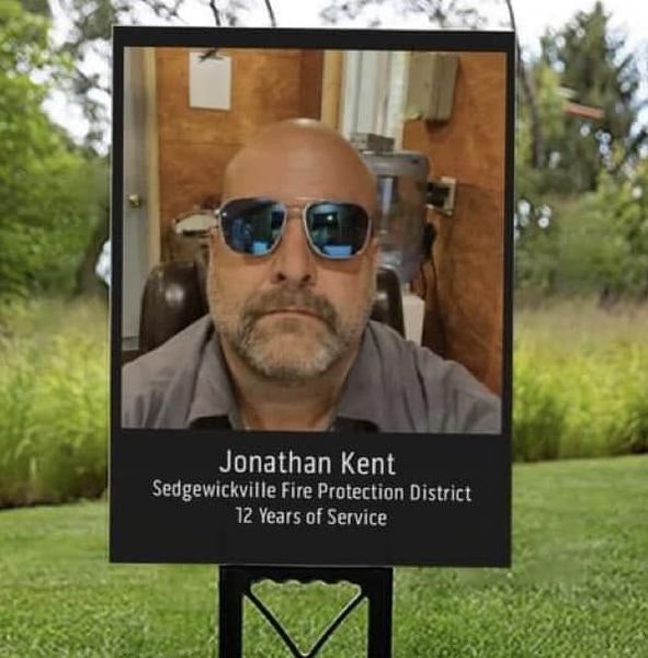 May contain: accessories, sunglasses, advertisement, grass, plant, photography, face, head, person, portrait, adult, male, man, glasses, clothing, t-shirt, and poster