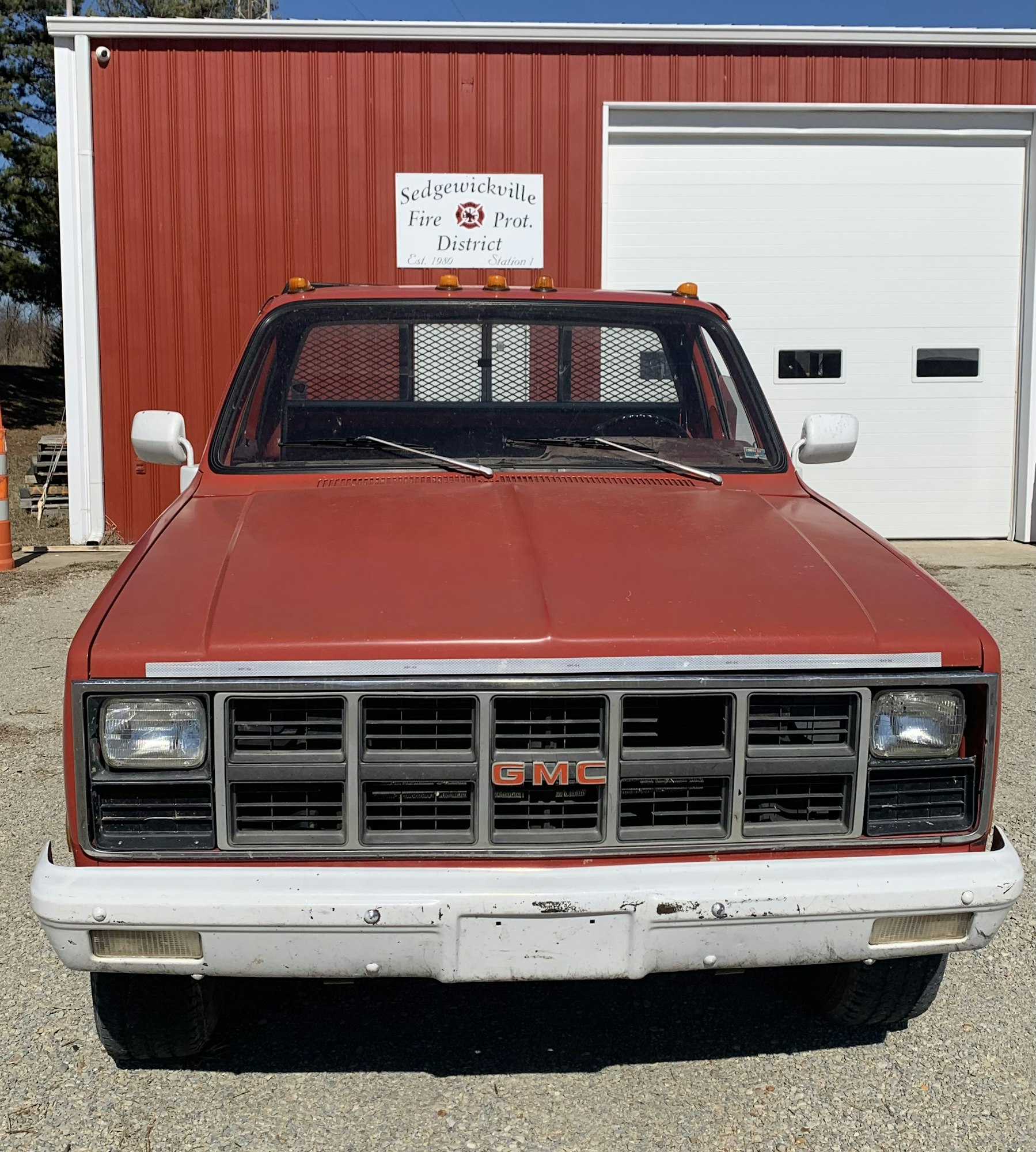 Red GMC truck in front of the Sedgewickville Fire & Protection District building.