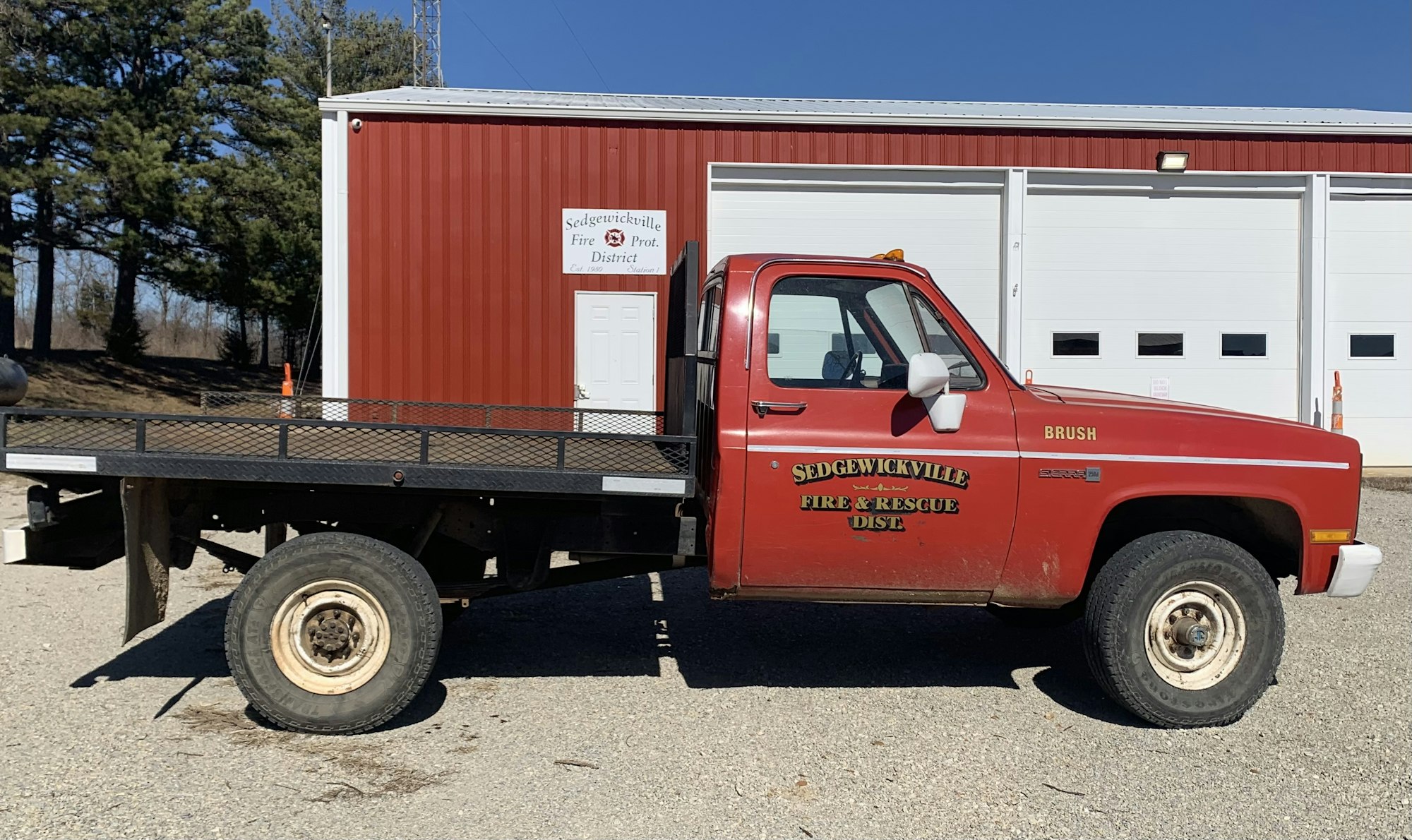 Red fire and rescue truck outside a fire station with the name "Sedgewickville Fire & Rescue DIST."