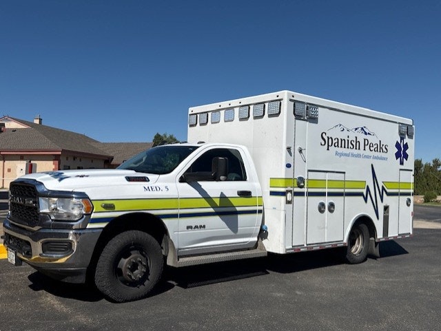 White ambulance with "Spanish Peaks Regional Health Center" logo parked outdoors.