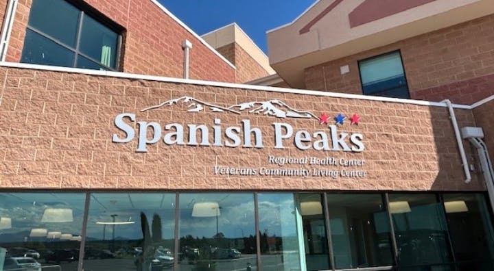 Building with "Spanish Peaks" signage, indicating a regional health center and veterans community living center.