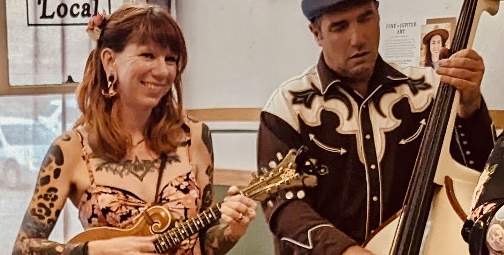 Two musicians playing a mandolin and an upright bass.
