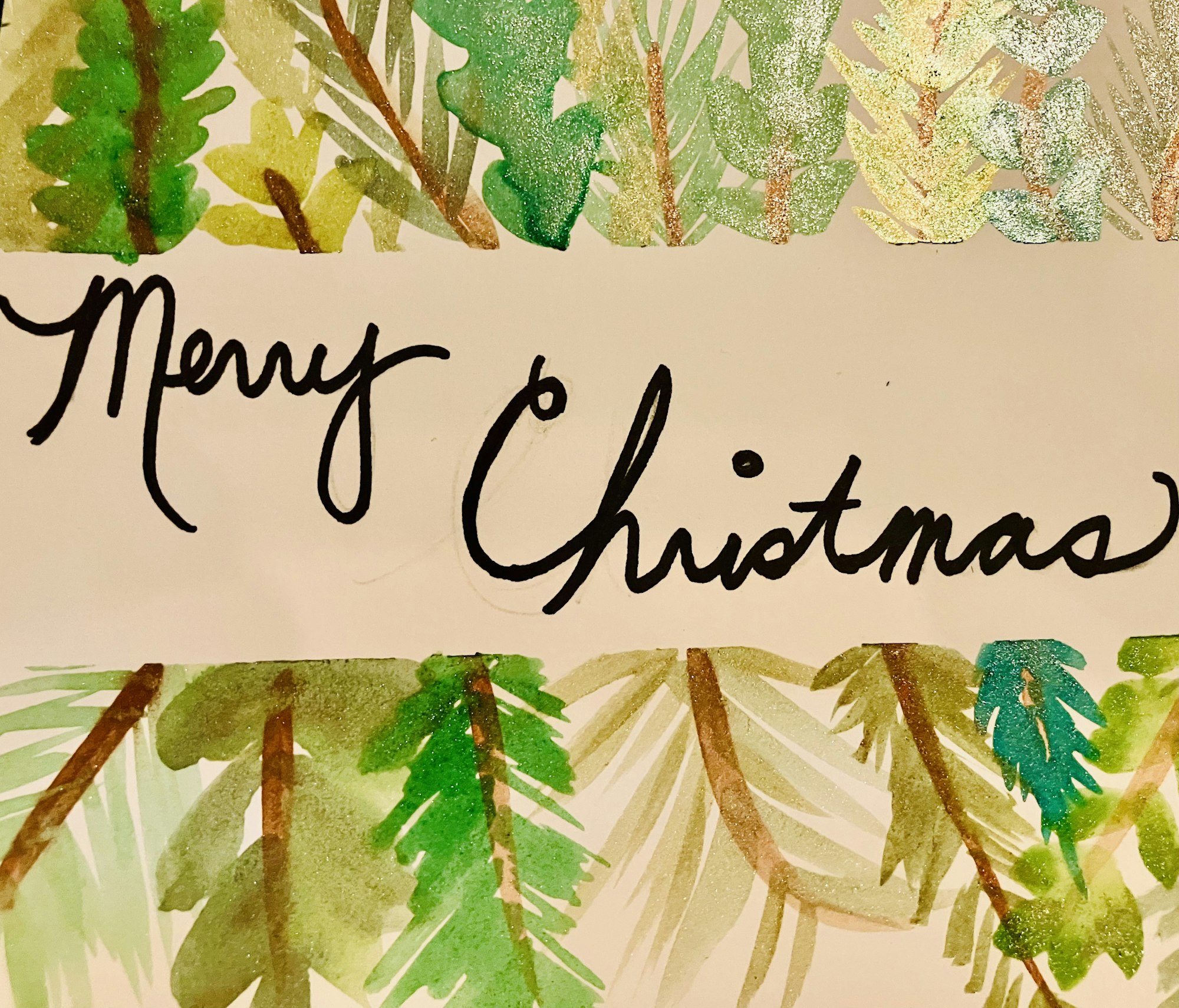 A festive design featuring “Merry Christmas” in elegant script, surrounded by green foliage and decorative elements.
