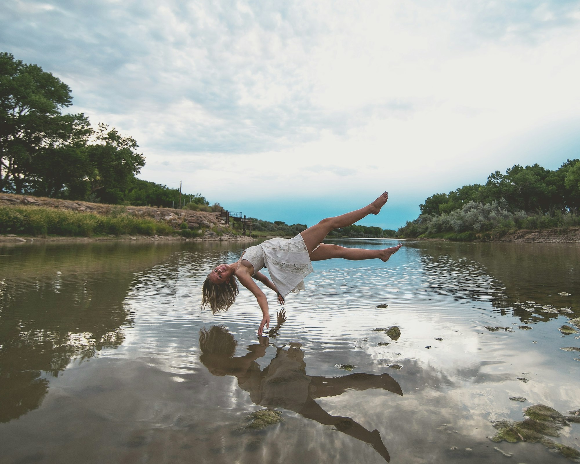 Photo by Josh Beckner of a woman hovering over a river.