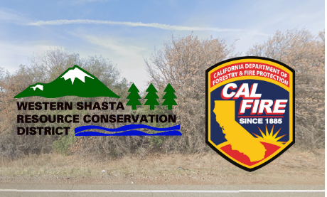 Two signs: Western Shasta Resource Conservation District and Cal Fire, roadside with trees and sky in the background.