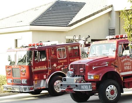 Two fire trucks parked in front of a building.
