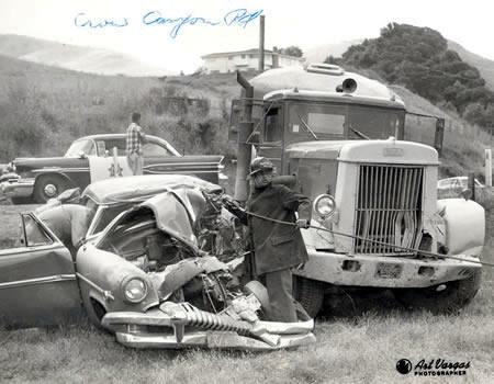 A black-and-white photo of a car crash scene with a damaged car and a truck.