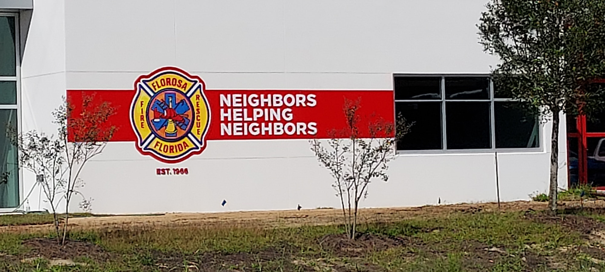 May contain: wall, building, architecture, logo, and plant