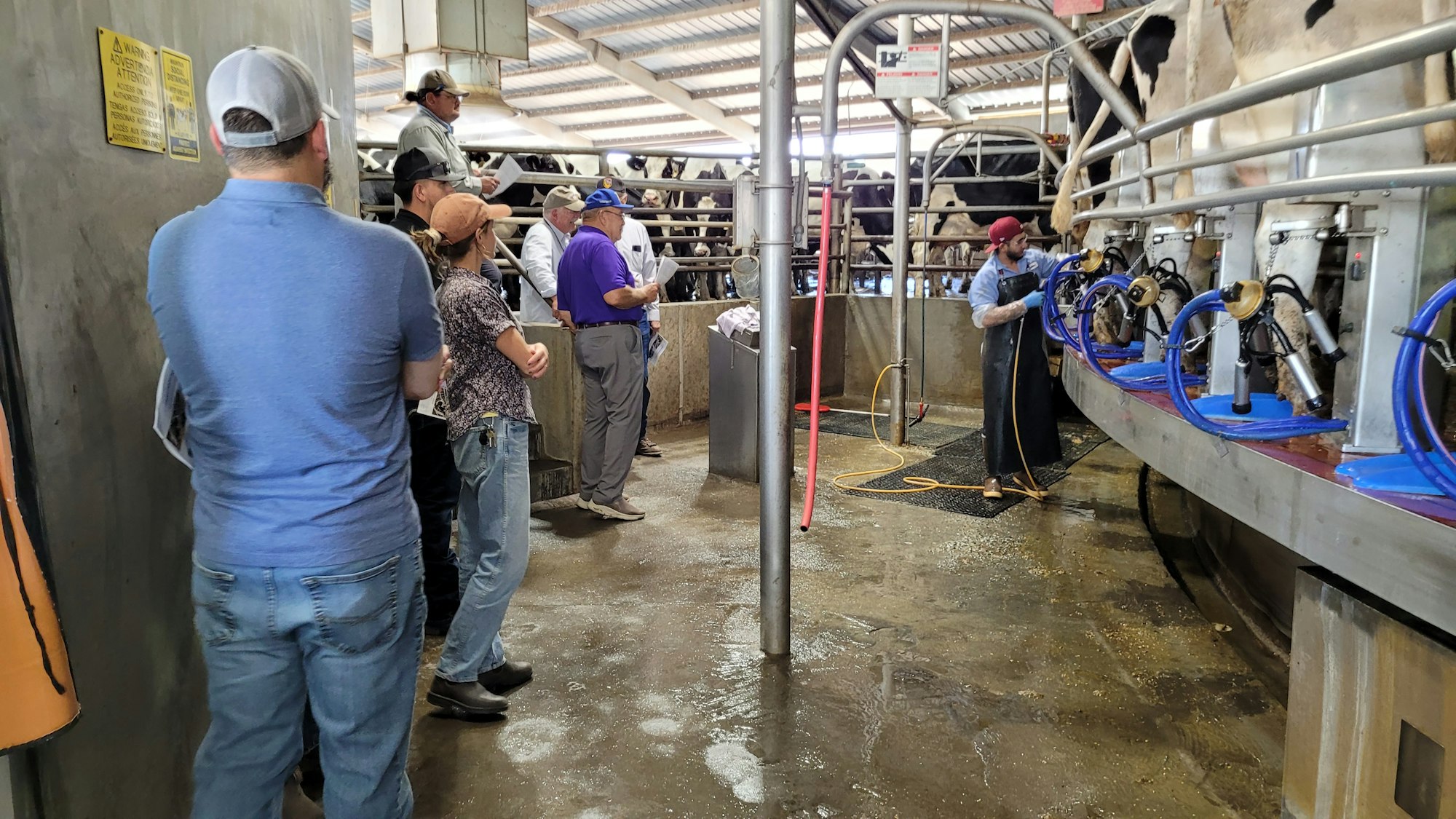 May contain: architecture, building, factory, clothing, hat, footwear, shoe, adult, male, man, person, manufacturing, glove, workshop, jeans, pants, and worker