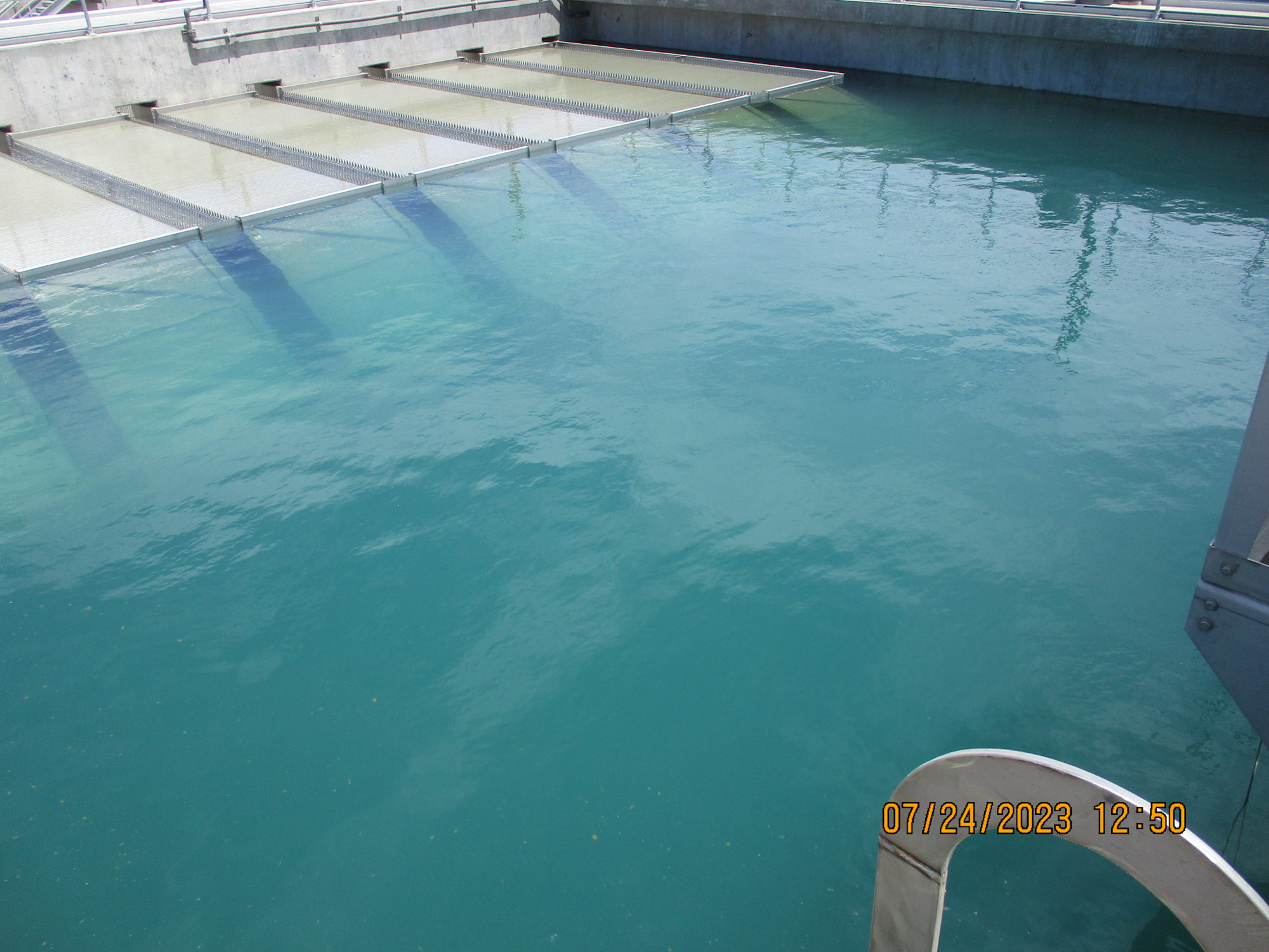 A water treatment facility with aeration tanks in daylight, timestamped "07/24/2023 12:50".