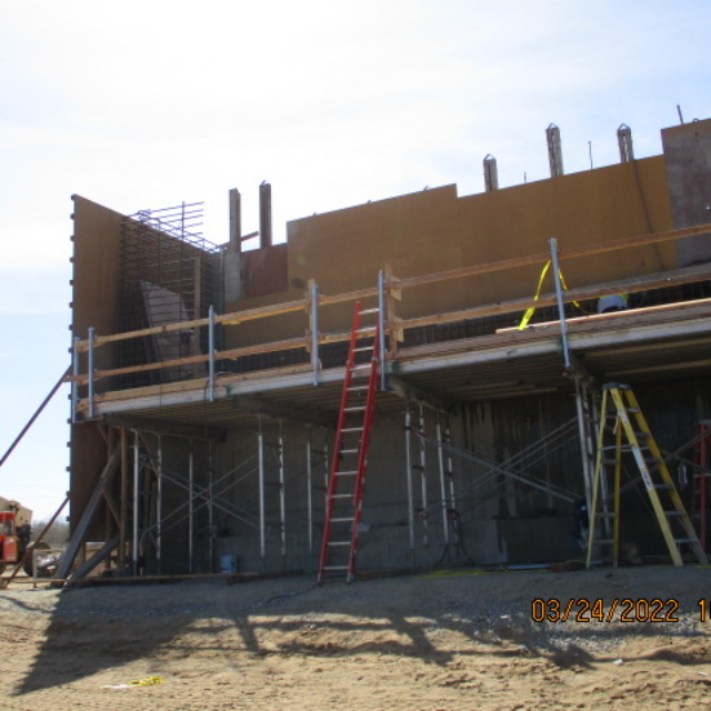 Construction site with scaffolding and ladders.