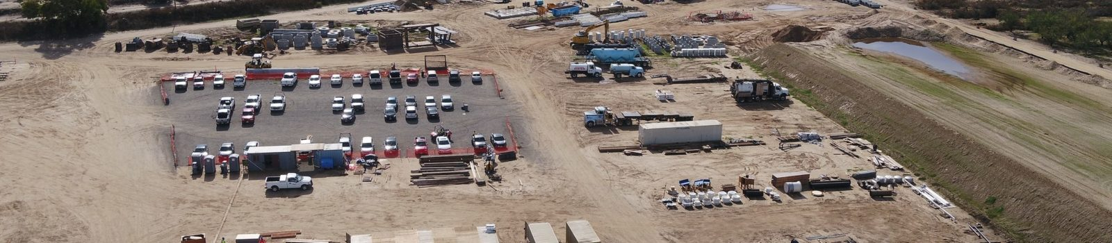 Aerial view of a construction site with equipment and vehicles.