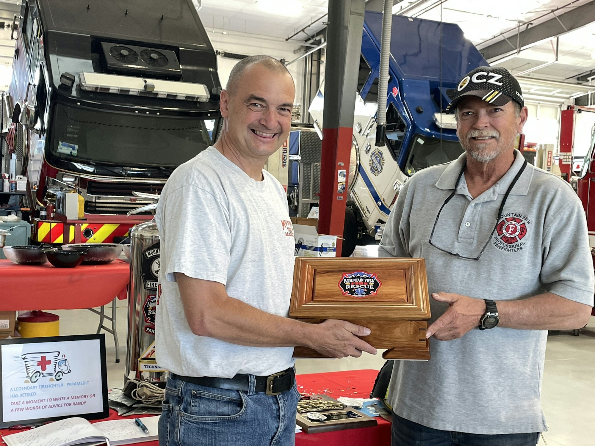May contain: face, head, person, photography, portrait, clothing, t-shirt, pen, wristwatch, hat, box, baseball cap, cap, adult, male, man, wood, architecture, building, factory, pants, accessories, and belt