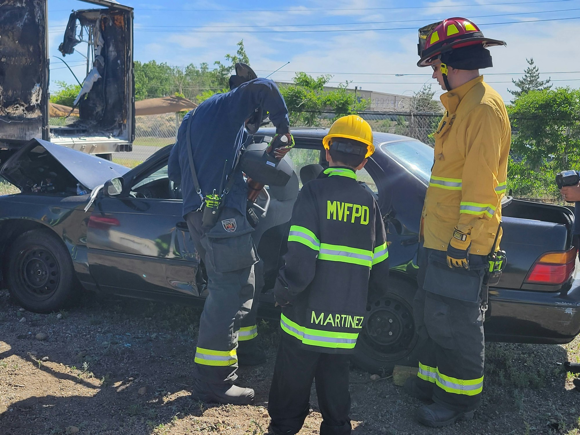 May contain: person, human, fireman, car, transportation, vehicle, automobile, wheel, machine, helmet, clothing, and apparel