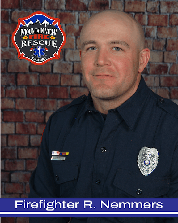 A portrait of a smiling firefighter in uniform with a fire department emblem and the name "Firefighter R. Nemmers."