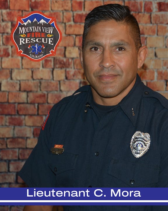 A firefighter in uniform with a "Mountain View Fire Rescue Colorado" badge in the background.