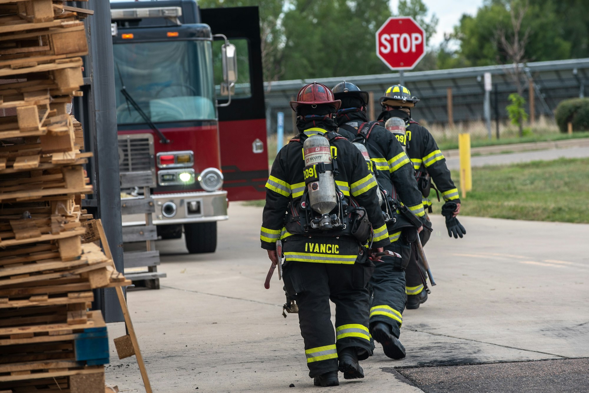 May contain: helmet, clothing, apparel, person, human, truck, transportation, vehicle, and fireman