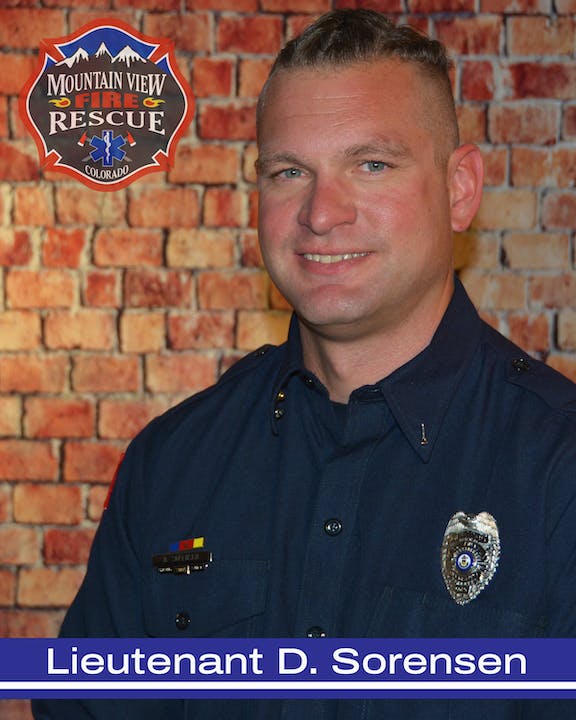 A portrait of a firefighter against a brick wall background, with a badge and the name "Lieutenant D. Sorensen" displayed below.