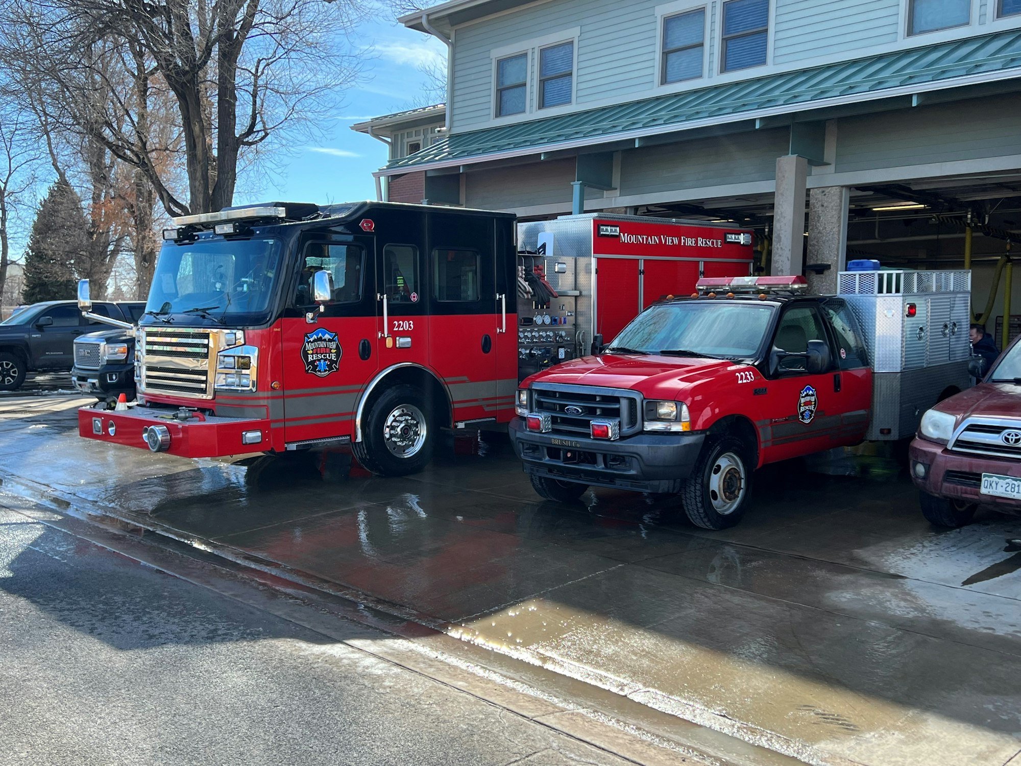May contain: car, vehicle, transportation, person, fire station, truck, and fire truck