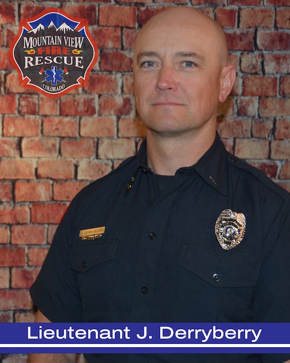 A person in a firefighter uniform with insignia from Mountain View Fire Rescue, Colorado.