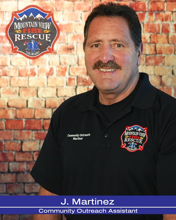 A person in a Mountain View Fire Rescue shirt, with a badge, and the name "J. Martinez, Community Outreach Assistant."