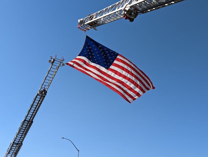 May contain: flag, construction, construction crane, and american flag