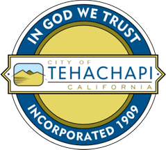 Seal of Tehachapi, California, with "In God We Trust" and "Incorporated 1909" text.