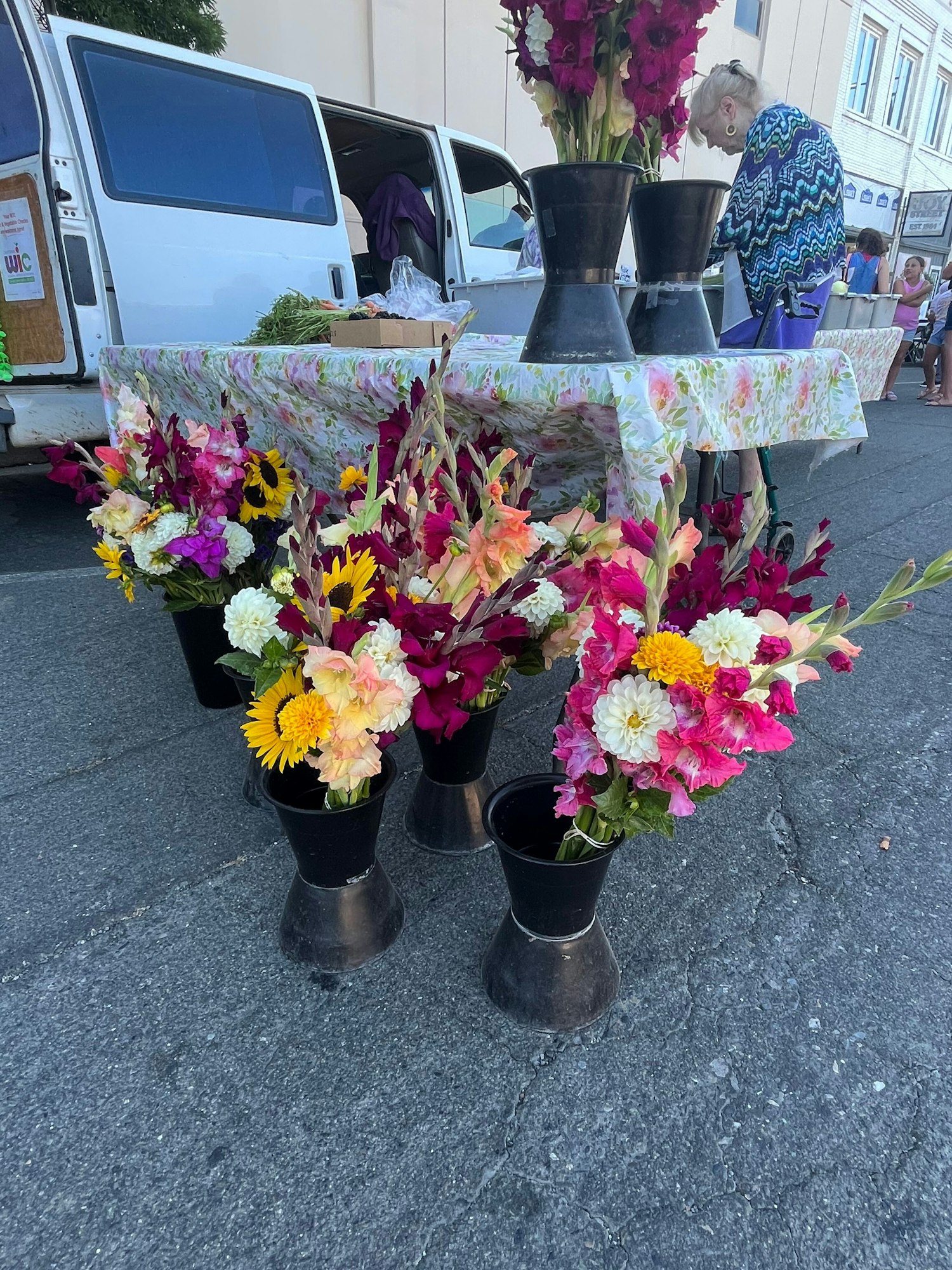 May contain: flower, flower arrangement, plant, flower bouquet, person, car, transportation, and vehicle