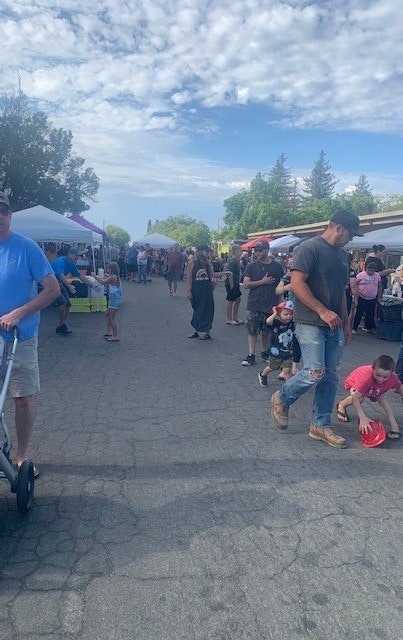 May contain: city, road, street, urban, people, person, clothing, footwear, shoe, hat, adult, male, man, architecture, building, outdoors, shelter, pants, photography, helmet, accessories, bag, handbag, walking, face, head, and portrait