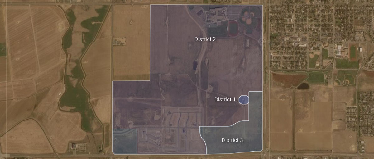 Aerial view of a divided area with labeled districts, showing farmland, a small town, and infrastructure.