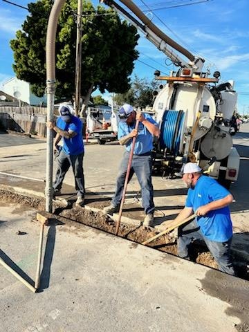 May contain: person, worker, utility pole, clothing, hardhat, and helmet