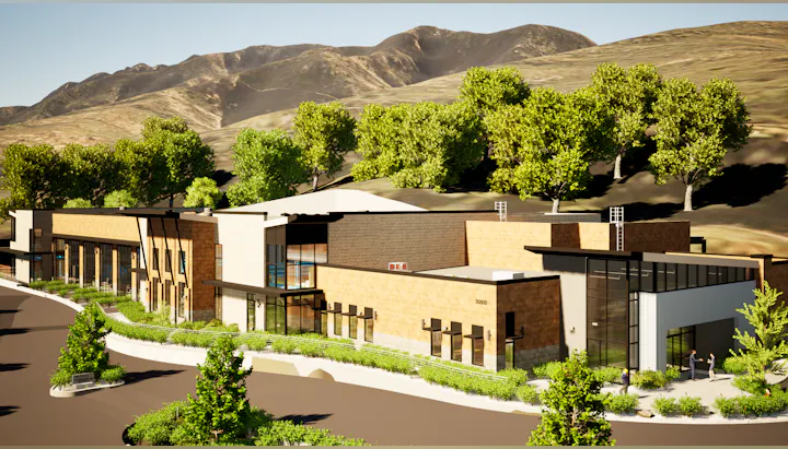 A modern building set against a mountain backdrop, surrounded by greenery and pathways. It features a mix of architectural styles.