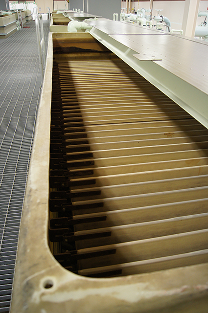 An industrial water filtration system with multiple horizontal plates in a row.