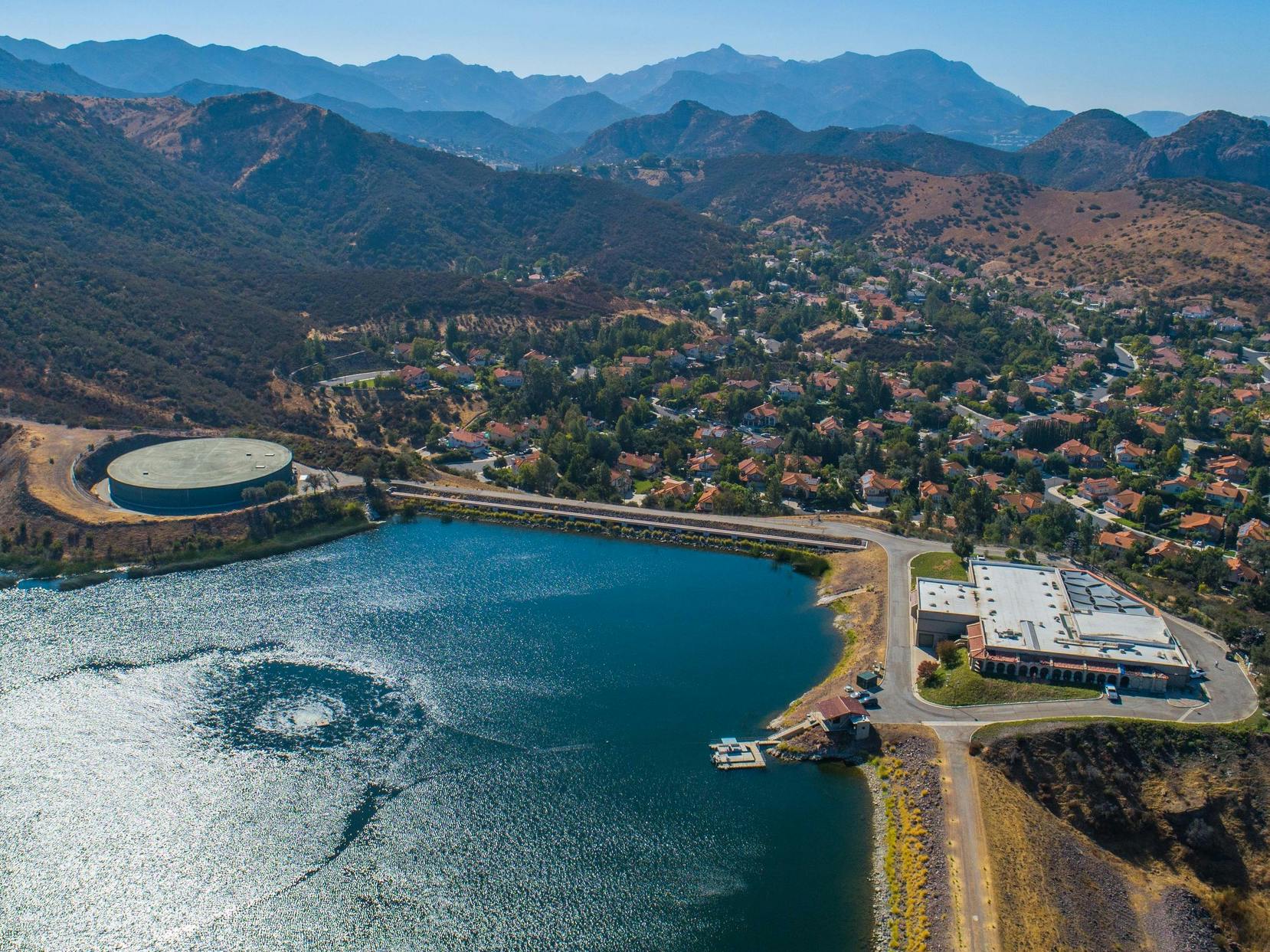 Aerial photo of the Las Virgenes Reservoir with the Filter Plant and Torchwood Water Tank overlooking the neighborhood of Three Srpings.