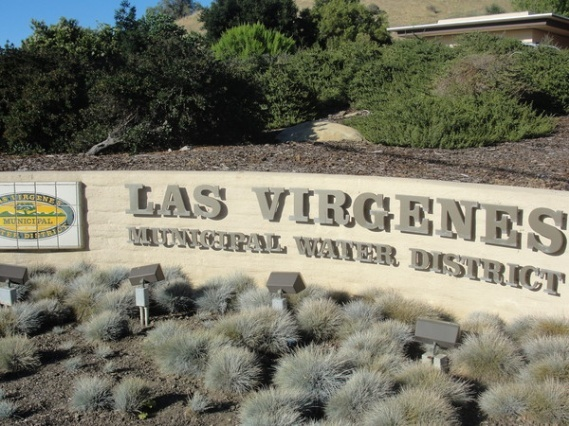 Sign for "Las Virgenes Municipal Water District" with greenery and shrubs in the background.