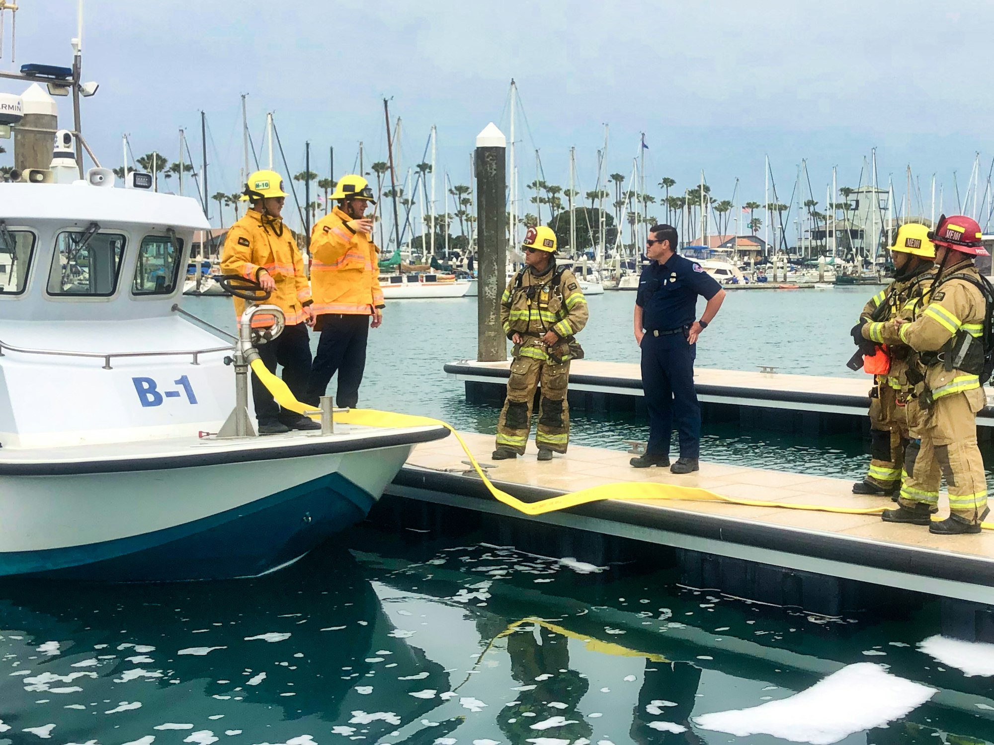 Harbor Patrol and Firefighters Talking About Hose Drill On Dock