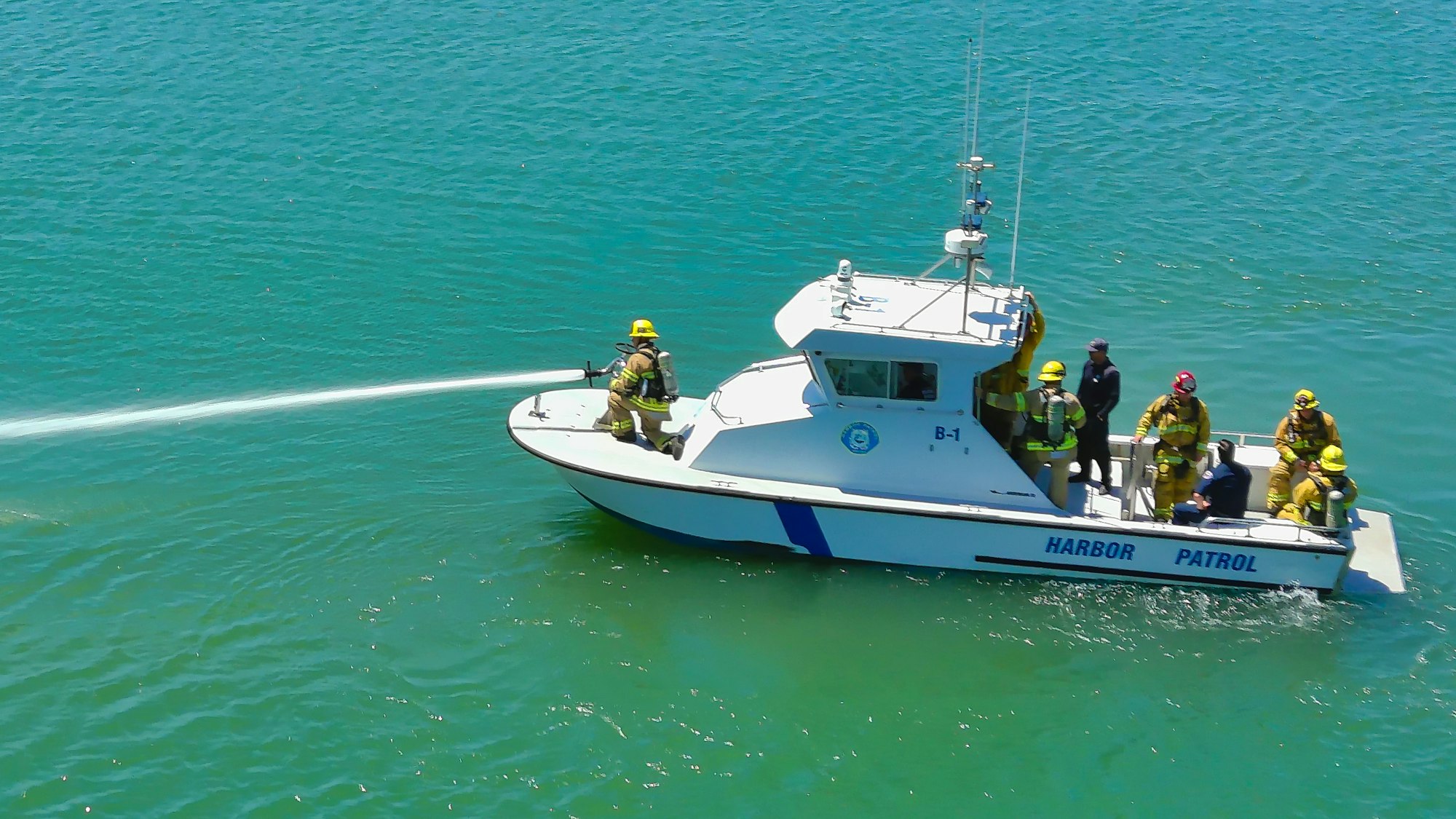 Harbor Patrol Fireboat Spraying Water From Deck Gun