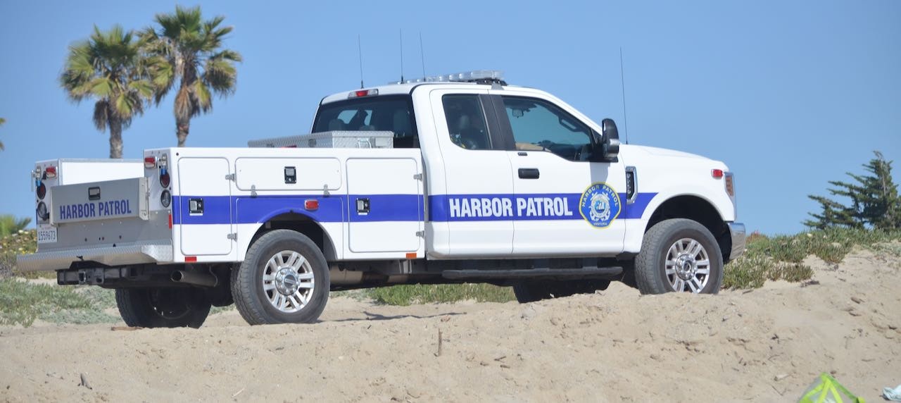 Harbor Patrol Ford Four Wheel Drive truck driving on the beach