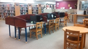 May contain: book, indoors, library, publication, chair, furniture, and table