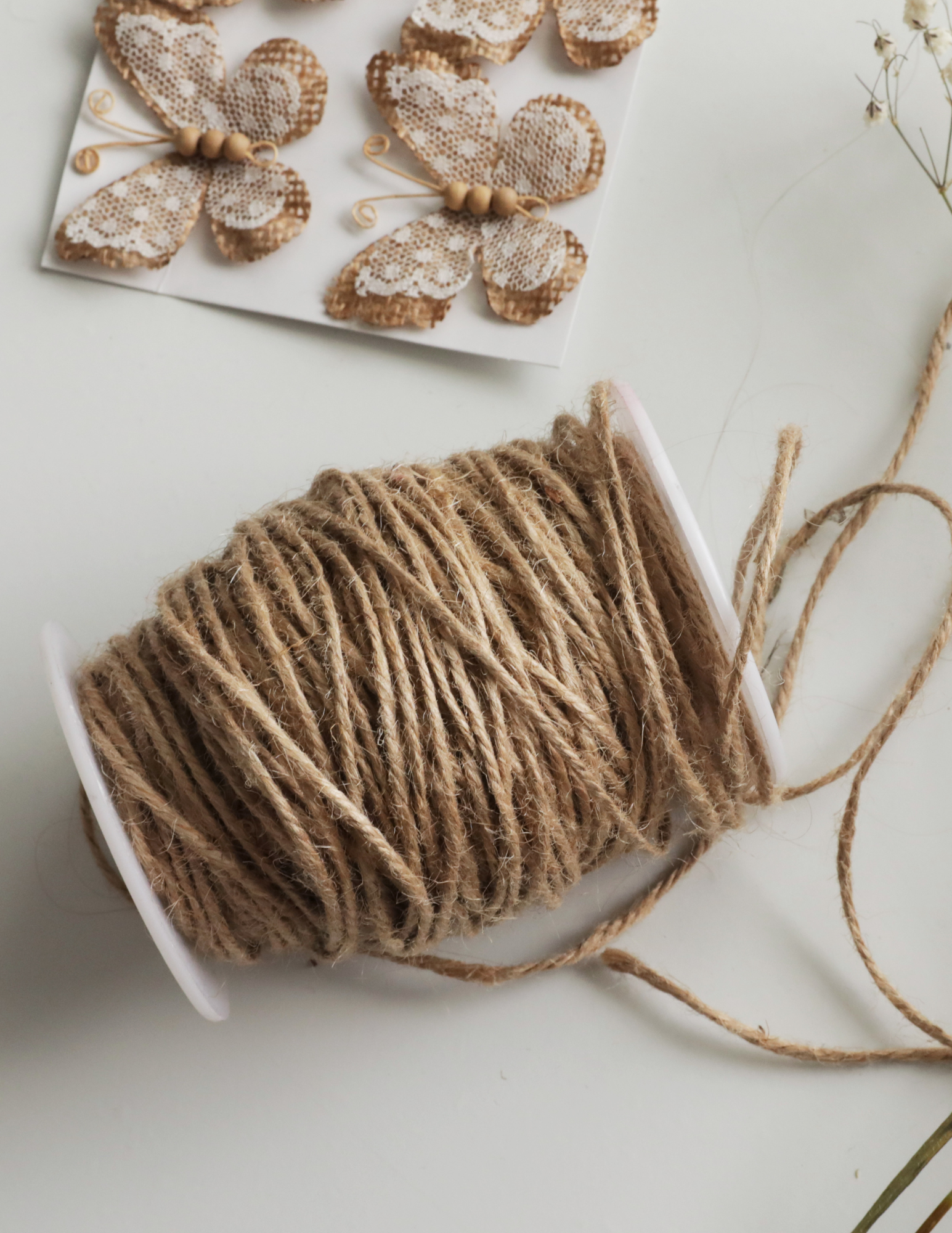 Includes a picture of craft supplies: A spool of thread and craft project