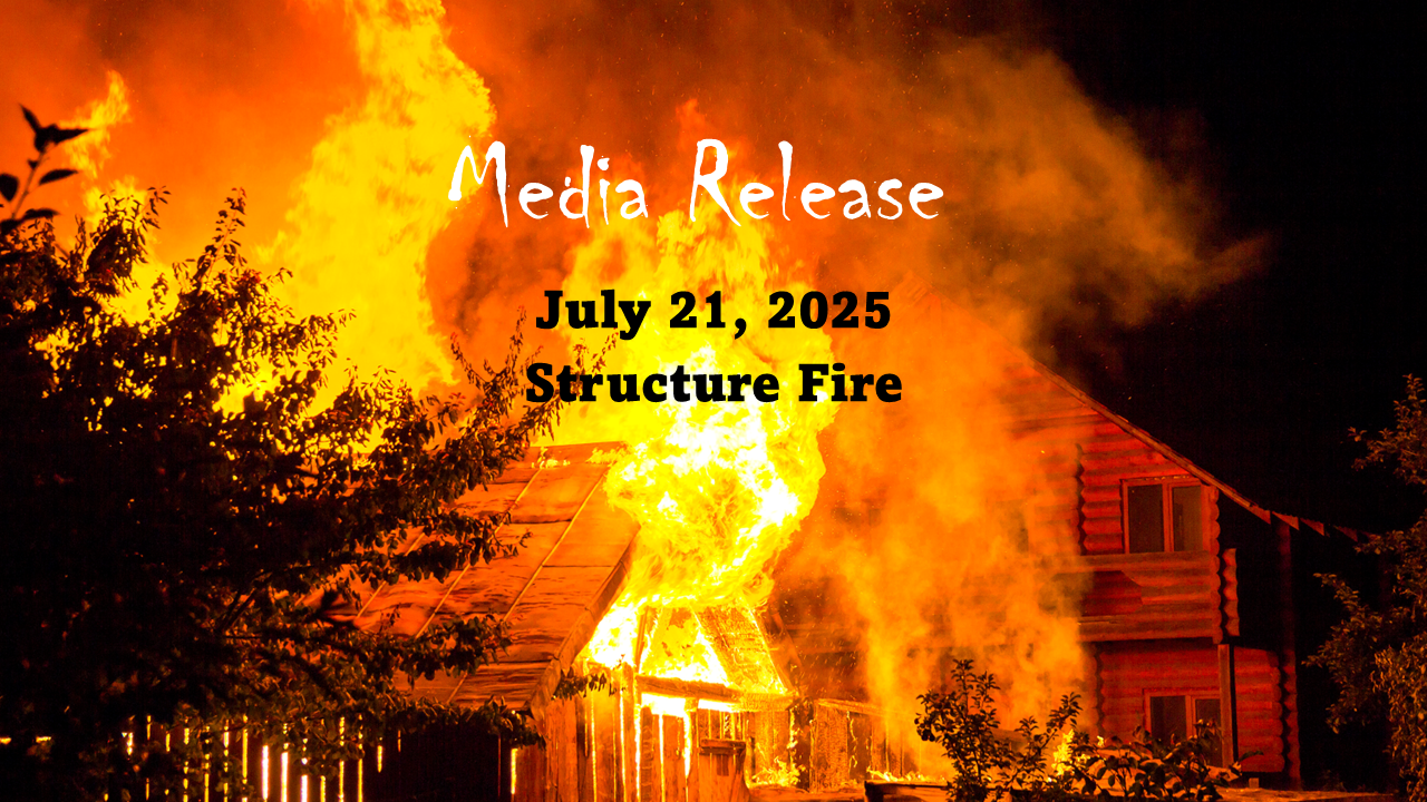 A wooden house engulfed in flames at night, with text: "Media Release, July 21, 2025, Structure Fire."