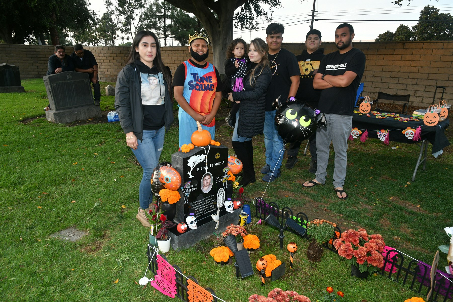 Family gathered around the grave of their love one