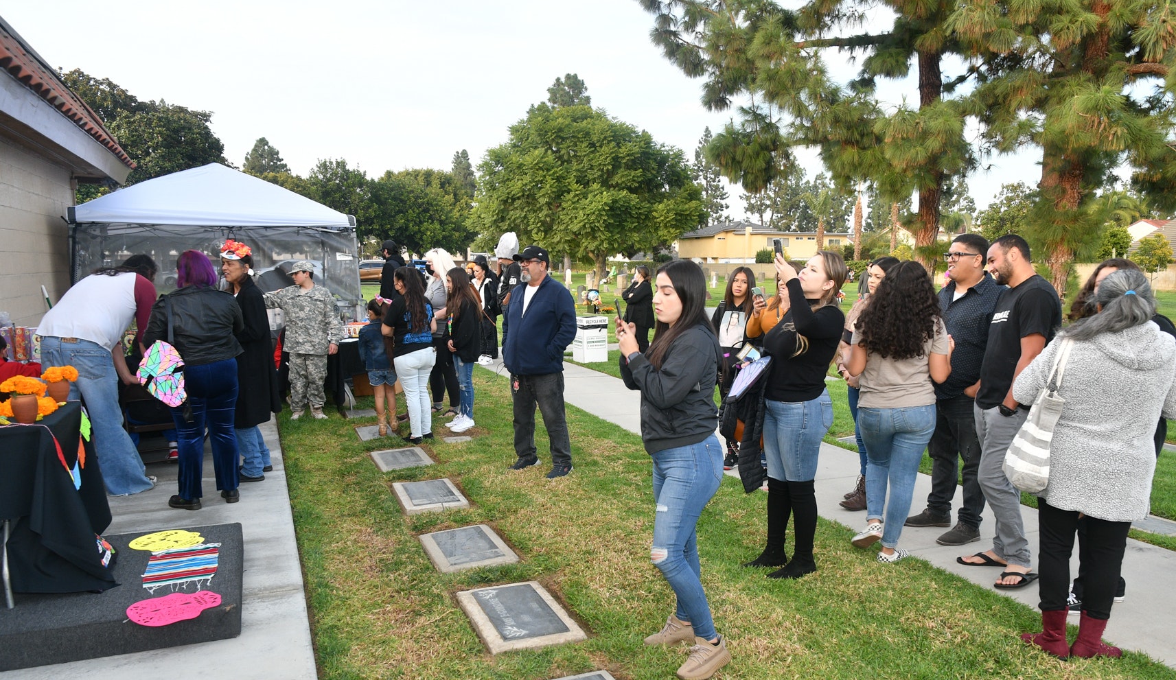 Members of the community observing the 'ofrenda' table