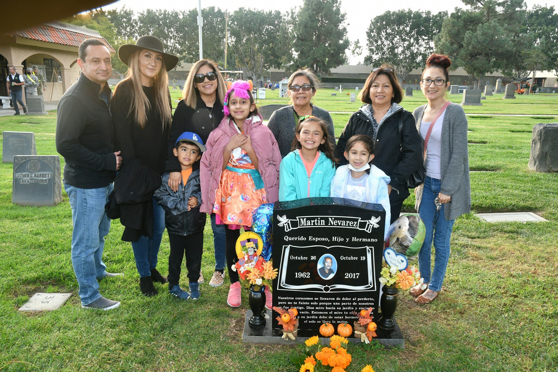 Family gathered around the grave of their love one
